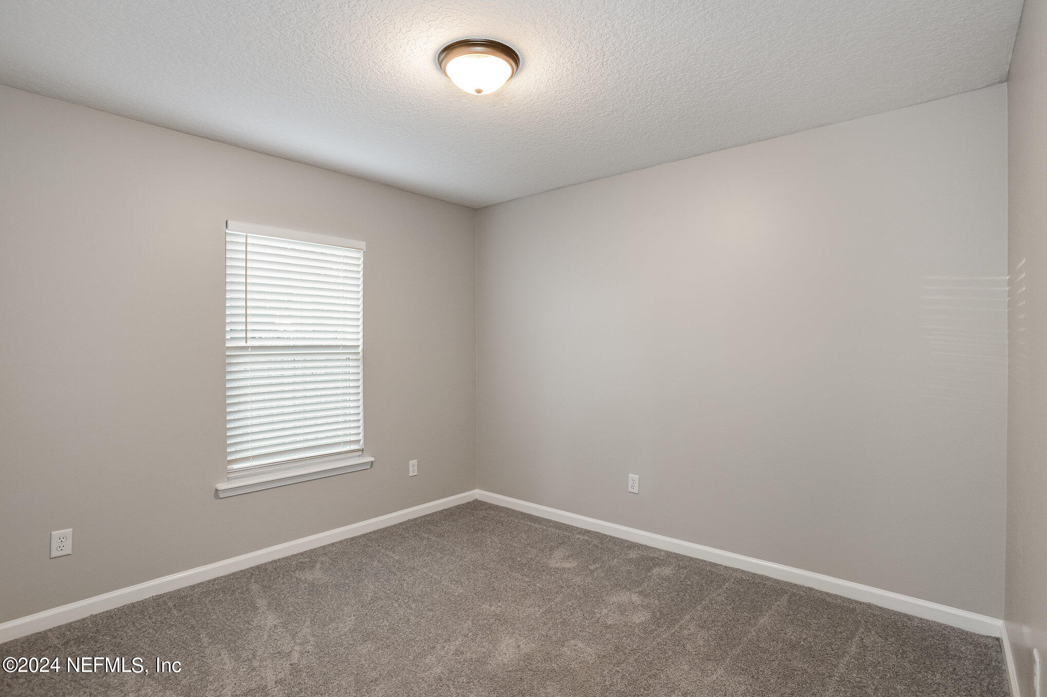 4595 Prunty Avenue Jacksonville, FL 32205 - Photo 11 of 15 an empty room with a window