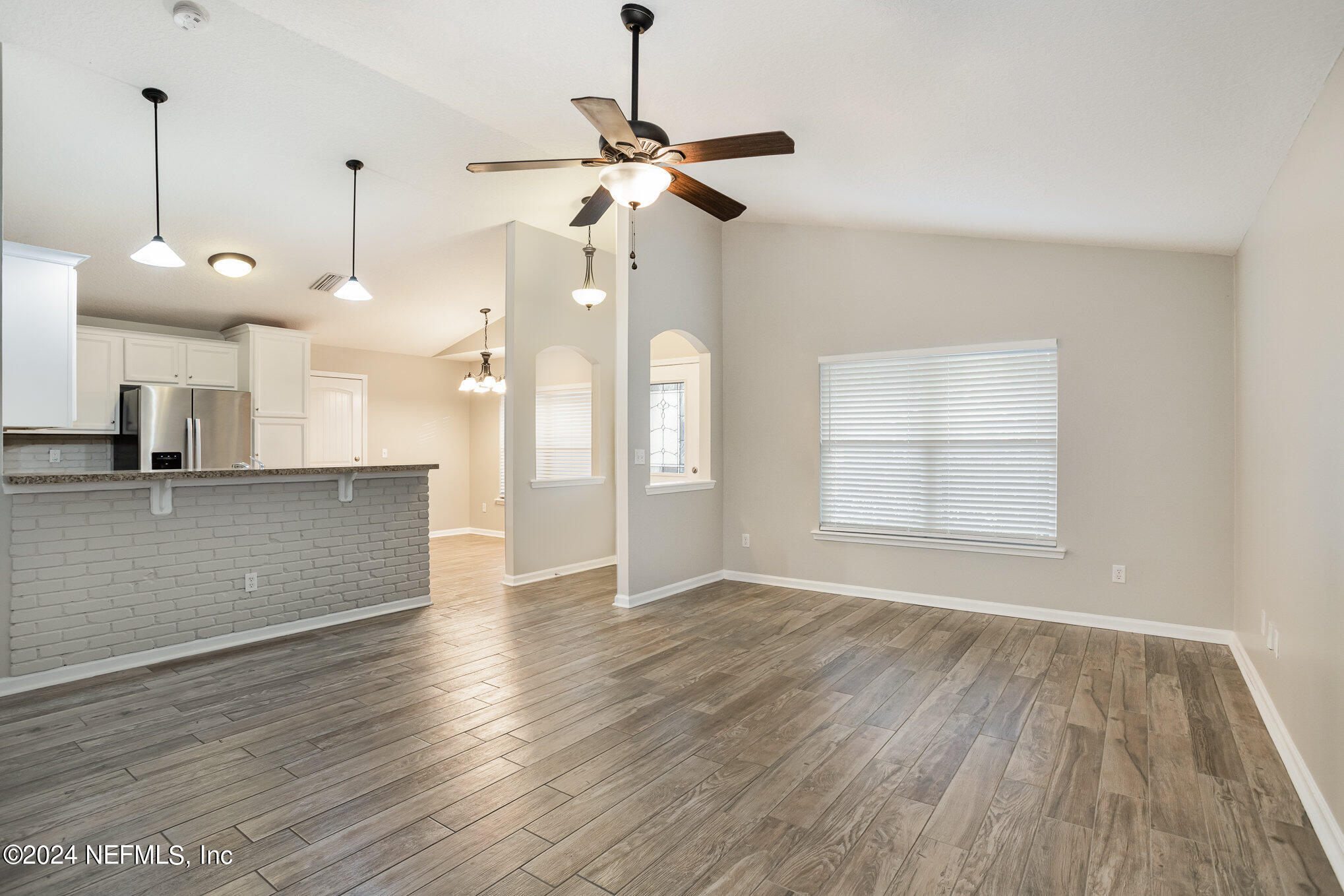 4595 Prunty Avenue Jacksonville, FL 32205 - Photo 3 of 15 a view of a room with wooden floor and a ceiling fan