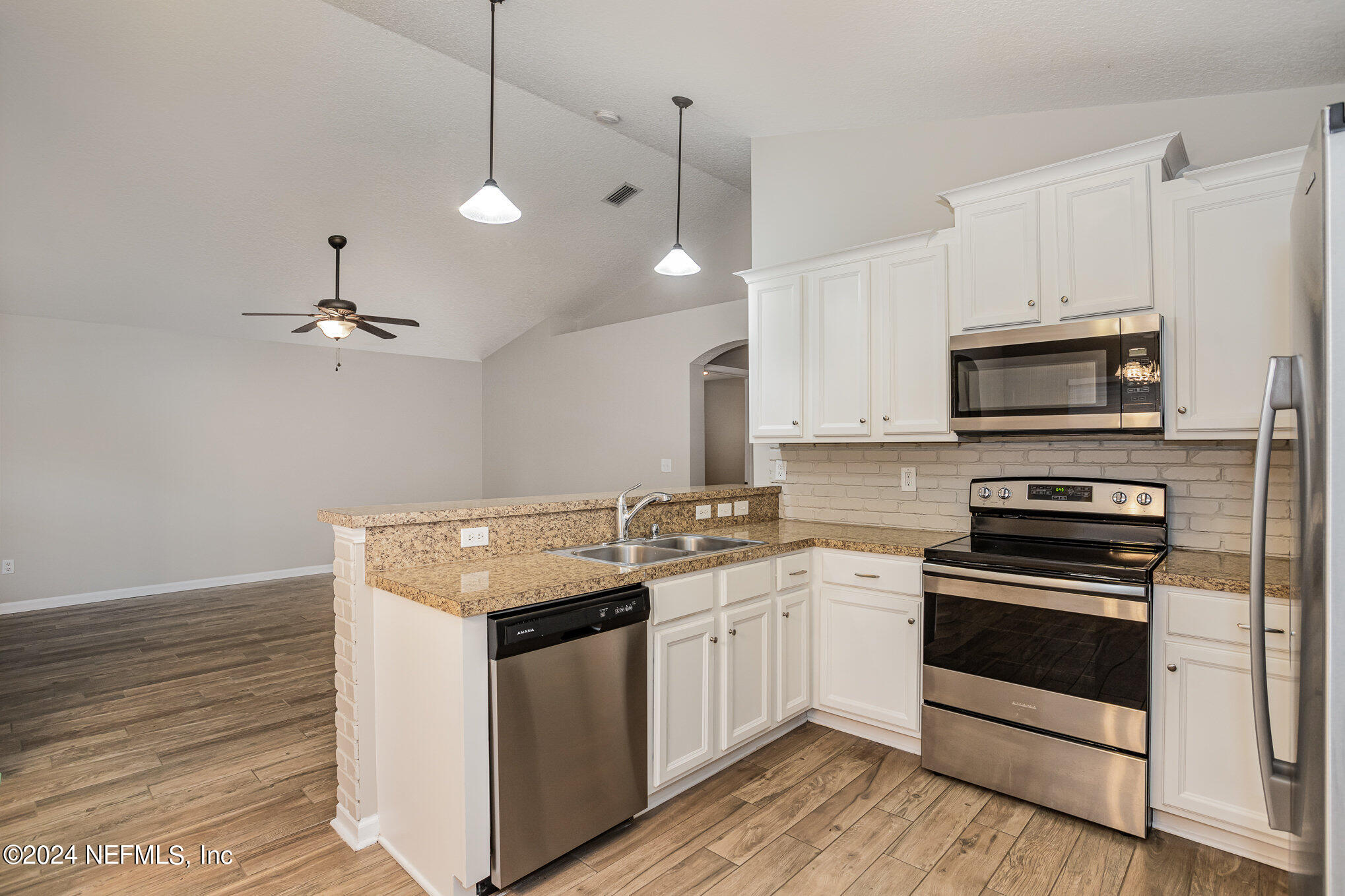 4595 Prunty Avenue Jacksonville, FL 32205 - Photo 5 of 15 a kitchen with granite countertop a sink stainless steel appliances and cabinets