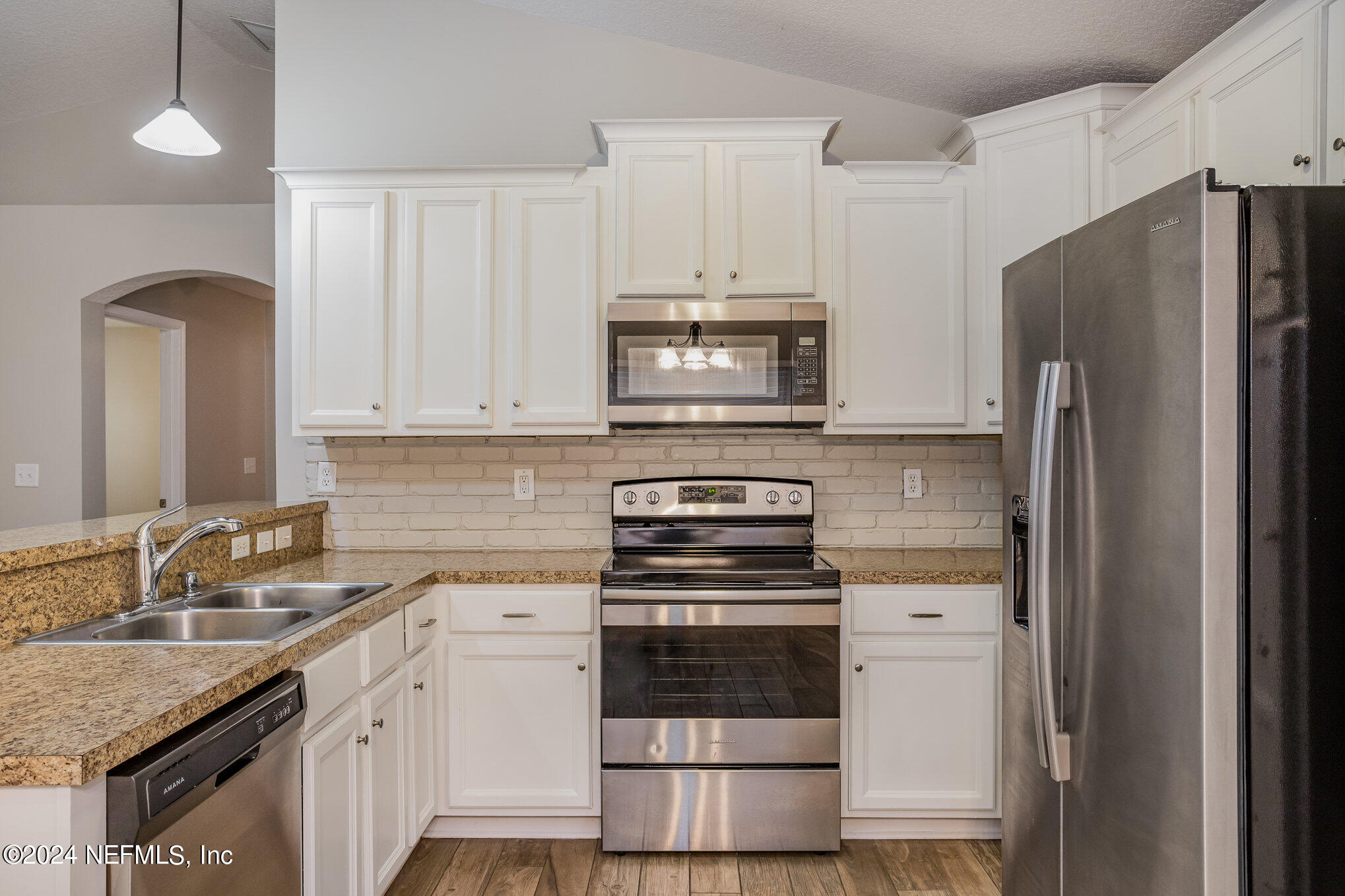 4595 Prunty Avenue Jacksonville, FL 32205 - Photo 6 of 15 a kitchen with granite countertop a refrigerator stove and sink