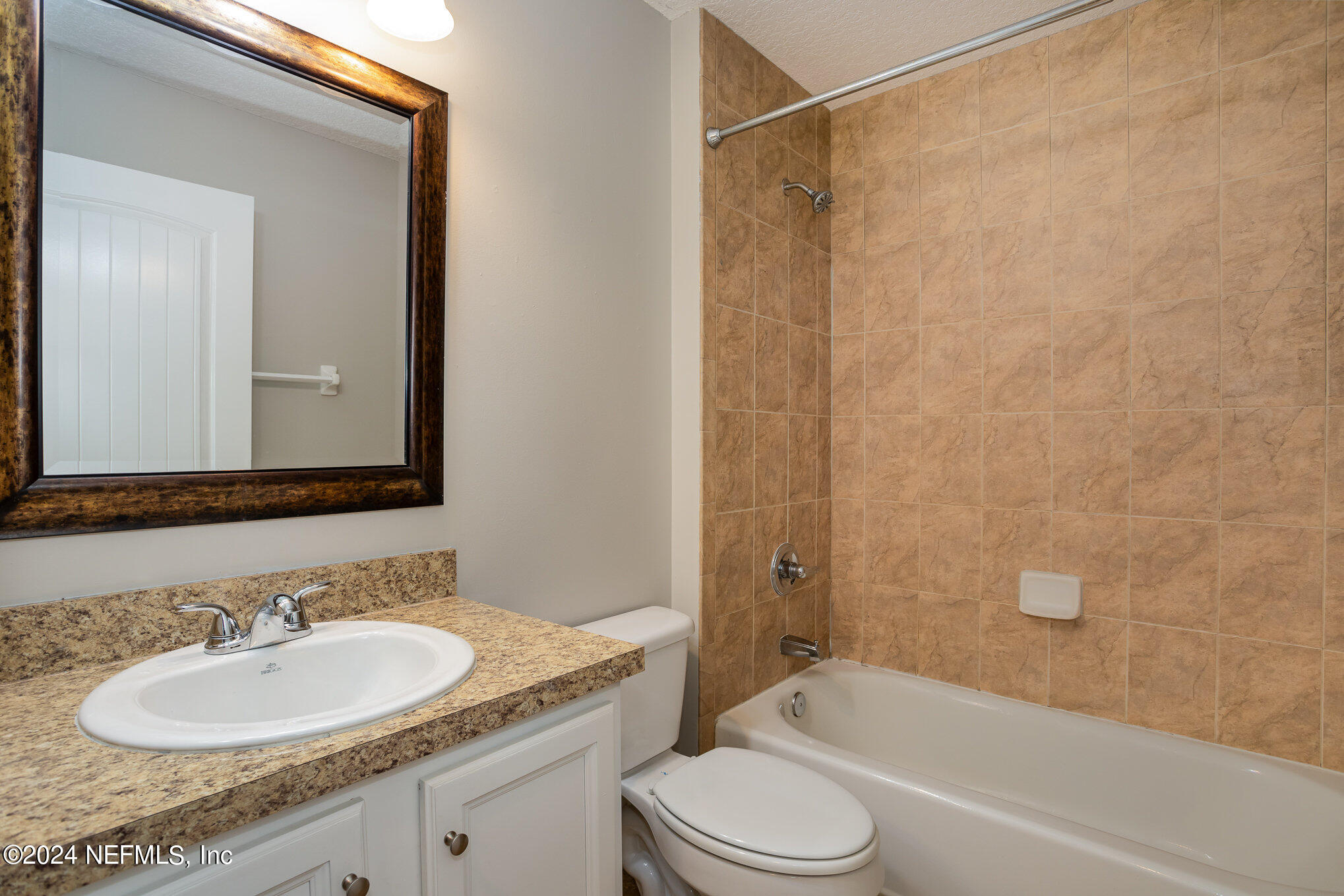 4595 Prunty Avenue Jacksonville, FL 32205 - Photo 8 of 15 a bathroom with a granite countertop sink toilet and shower