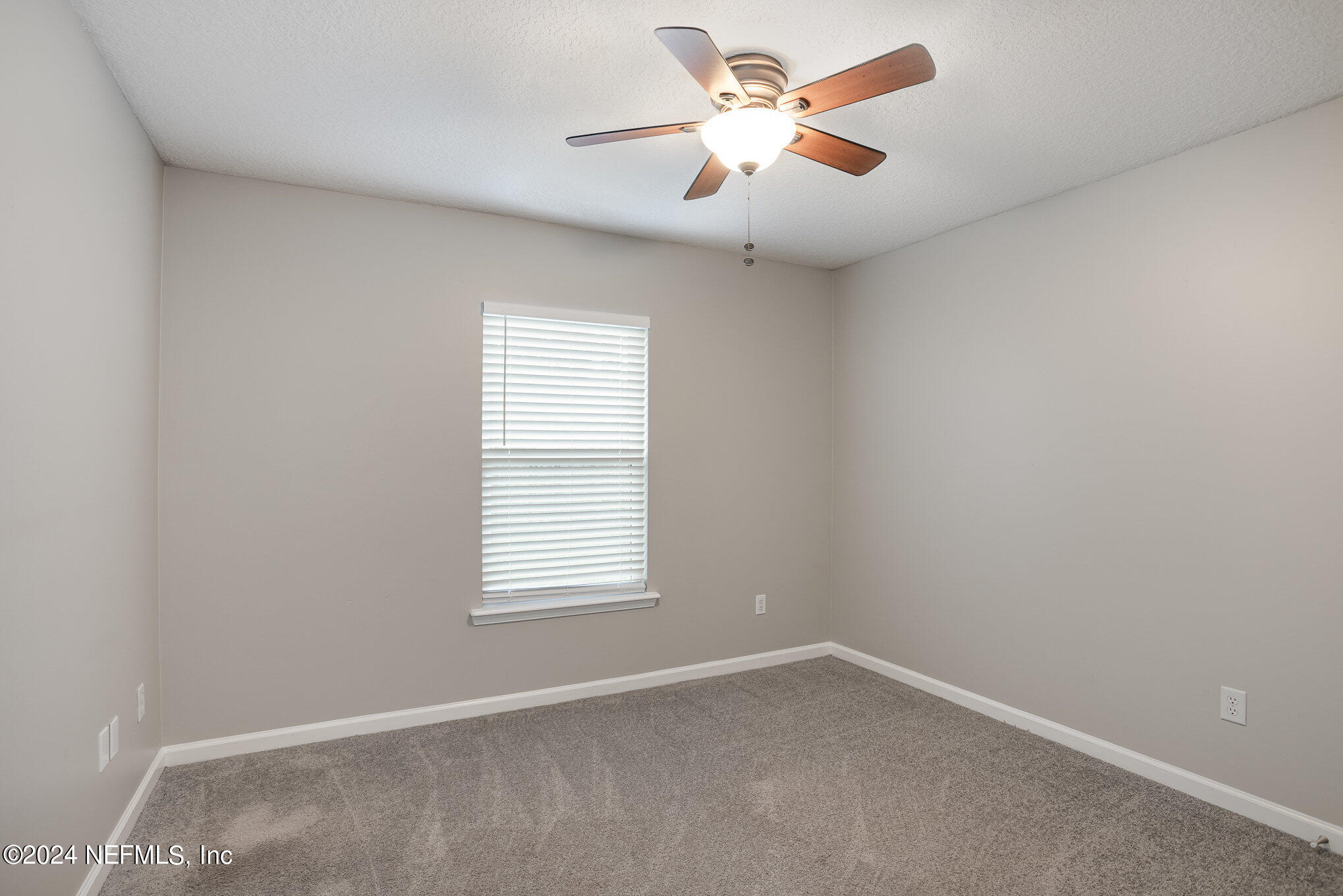 4595 Prunty Avenue Jacksonville, FL 32205 - Photo 10 of 15 an empty room with a window and a fan