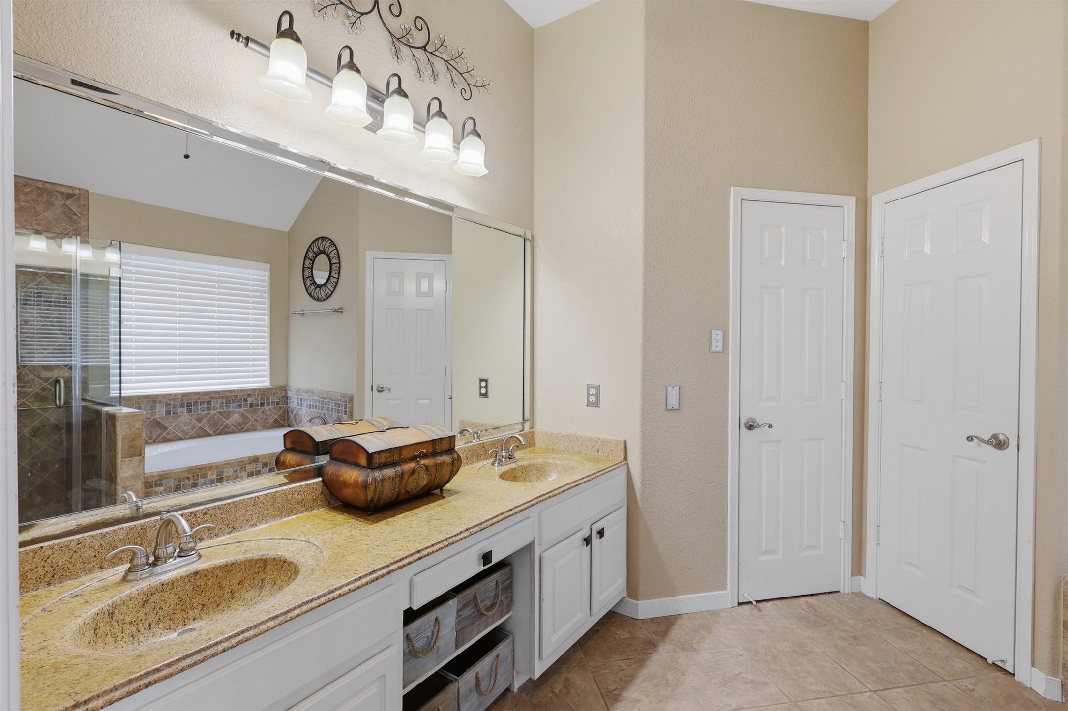 4838 Roaring Springs Road Pasadena, TX 77505 - Photo 20 of 38 Primary bathroom offers a dual-sink vanity and closets for added storage.