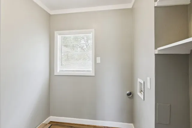 a view of a small space with wooden floor and a window