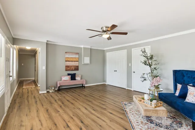 a bedroom with furniture and wooden floor