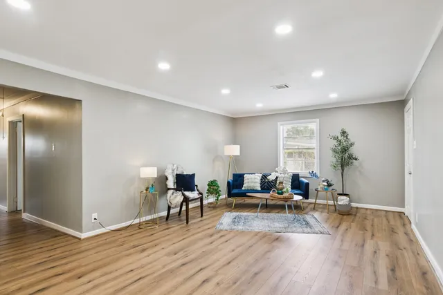 a view of a livingroom with furniture and wooden floor