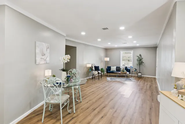 a view of a dining room with furniture and wooden floor