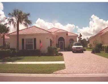 a view of a white house with a yard