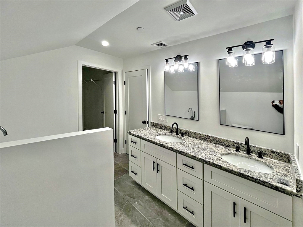 14 Dyer Street, Unit 14 Rockland, MA 02370 - Photo 12 of 16 a bathroom with a double vanity sink and mirror