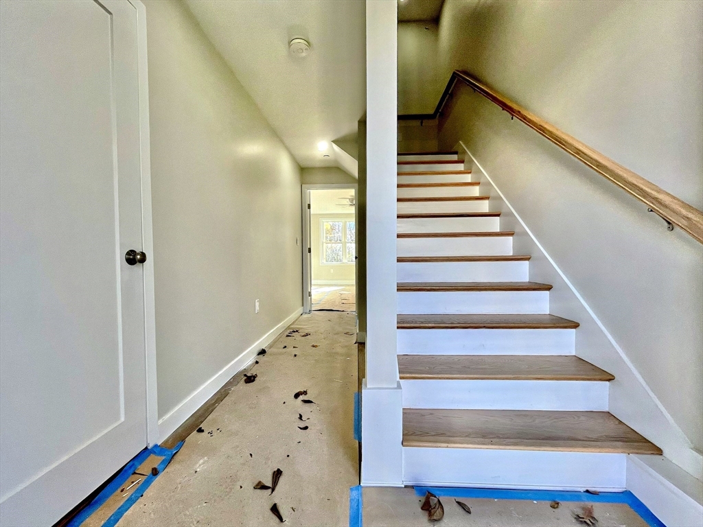 14 Dyer Street, Unit 14 Rockland, MA 02370 - Photo 2 of 16 a view of staircase with wooden floor and white walls