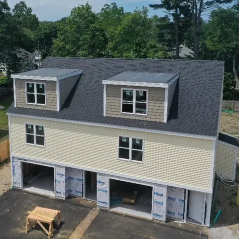 a front view of a house with parking area
