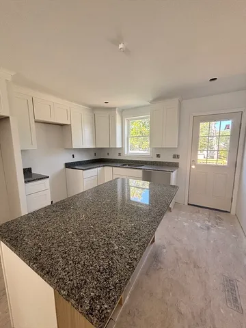 a kitchen with a stove a sink and a refrigerator