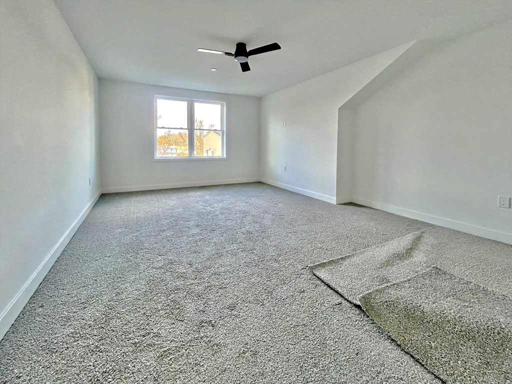 14 Dyer Street, Unit 14 Rockland, MA 02370 - Photo 9 of 16 an empty room with windows and ceiling fan
