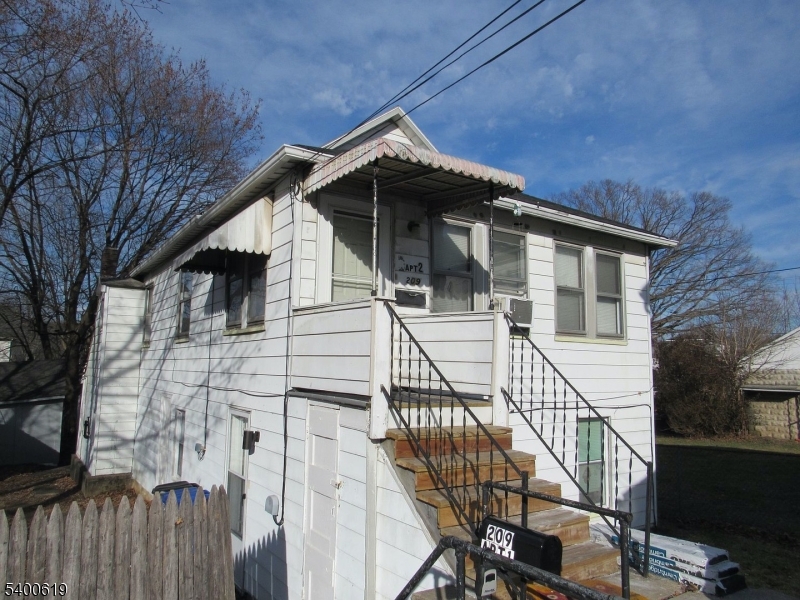 a front view of a house with wooden fence