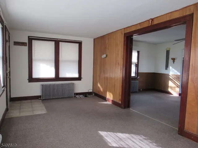 a view of empty room with wooden floor and cabinet
