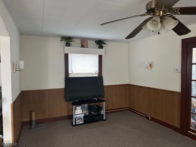 a room with gym equipment and a flat screen tv