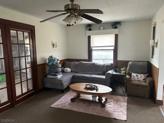 a living room with furniture a window and a chandelier