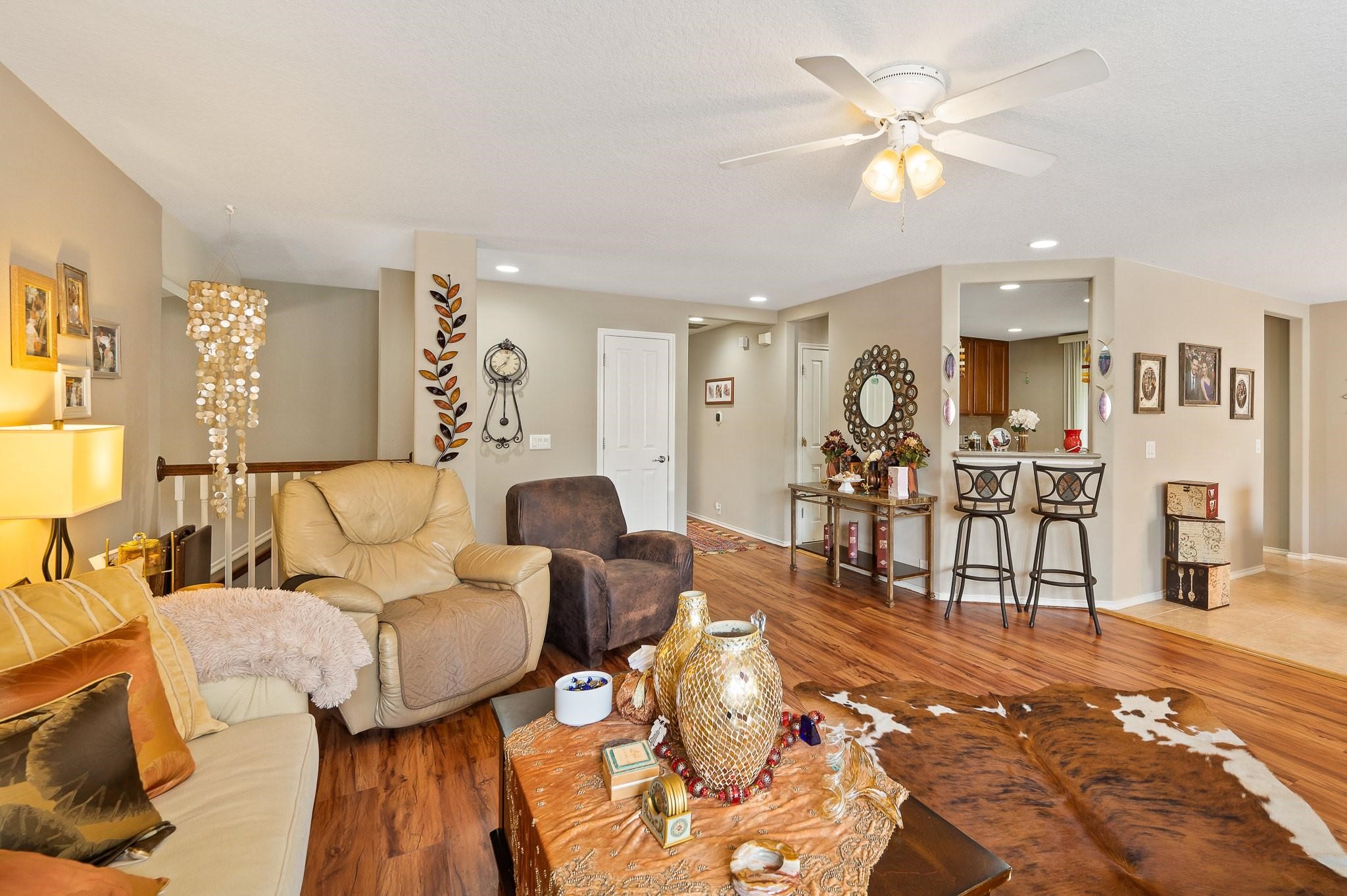 13600 Breton Ridge Street, Unit 25E Houston, TX 77070 - Photo 9 of 39 a living room with furniture and wooden floor