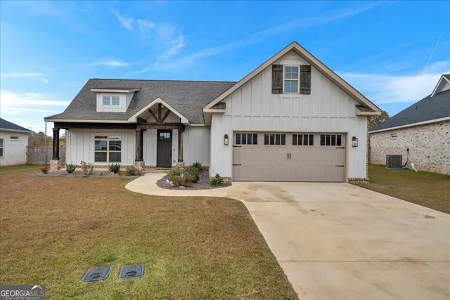 a front view of a house with yard and garage