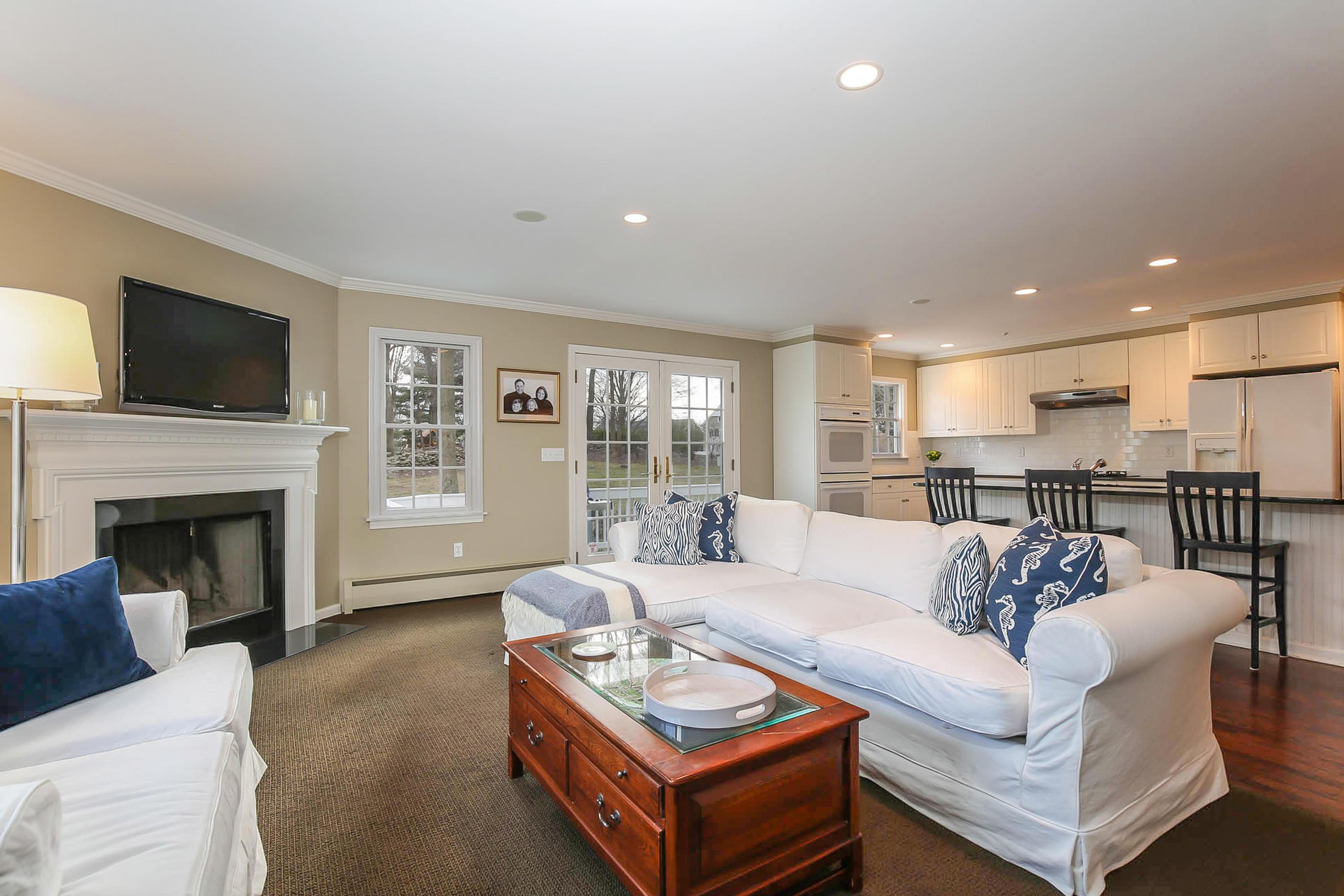25 Miles Road Darien, CT 06820 - Photo 13 of 30 a living room with furniture a fireplace and a flat screen tv