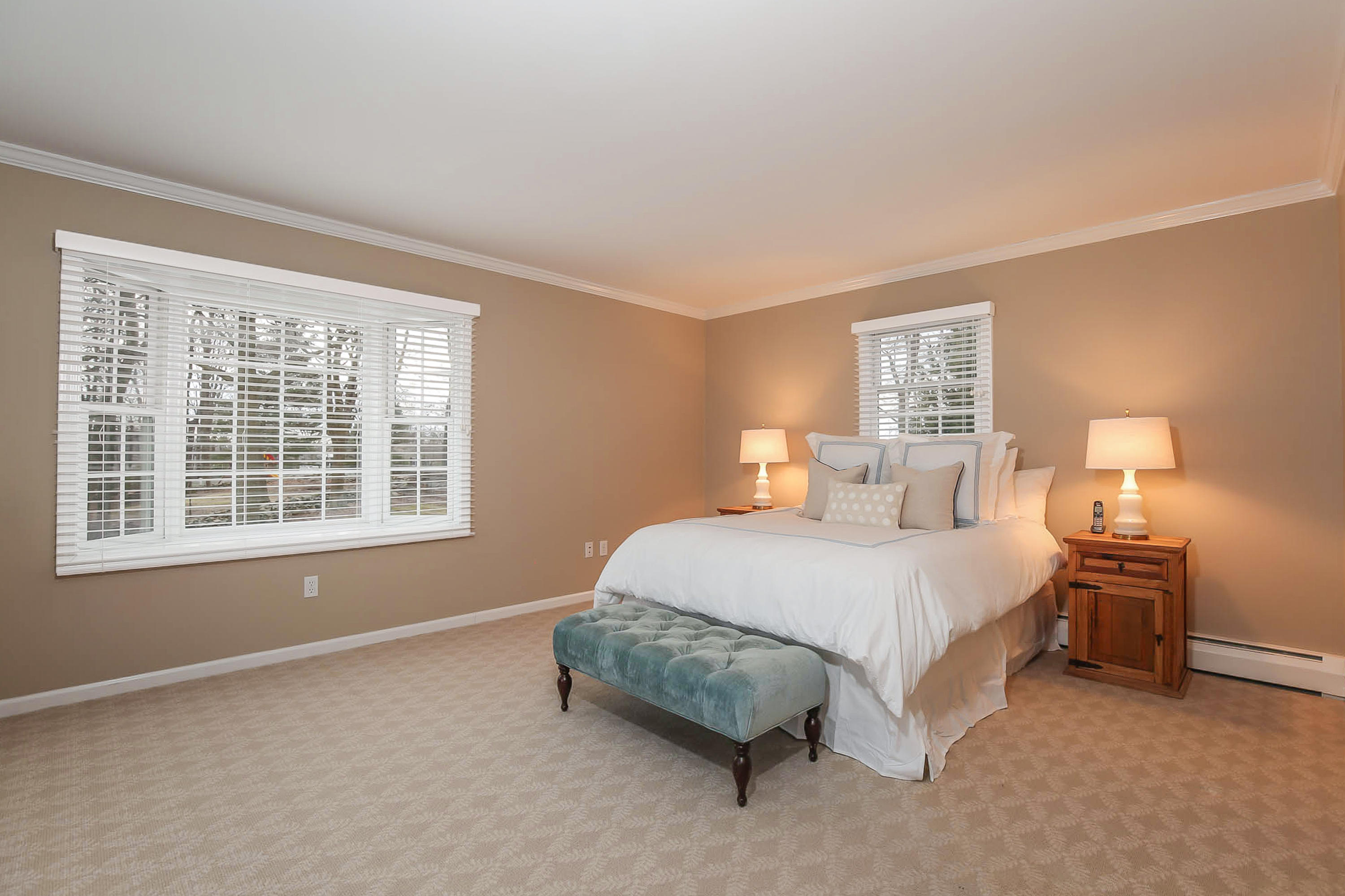25 Miles Road Darien, CT 06820 - Photo 17 of 30 a spacious bedroom with a bed and a window
