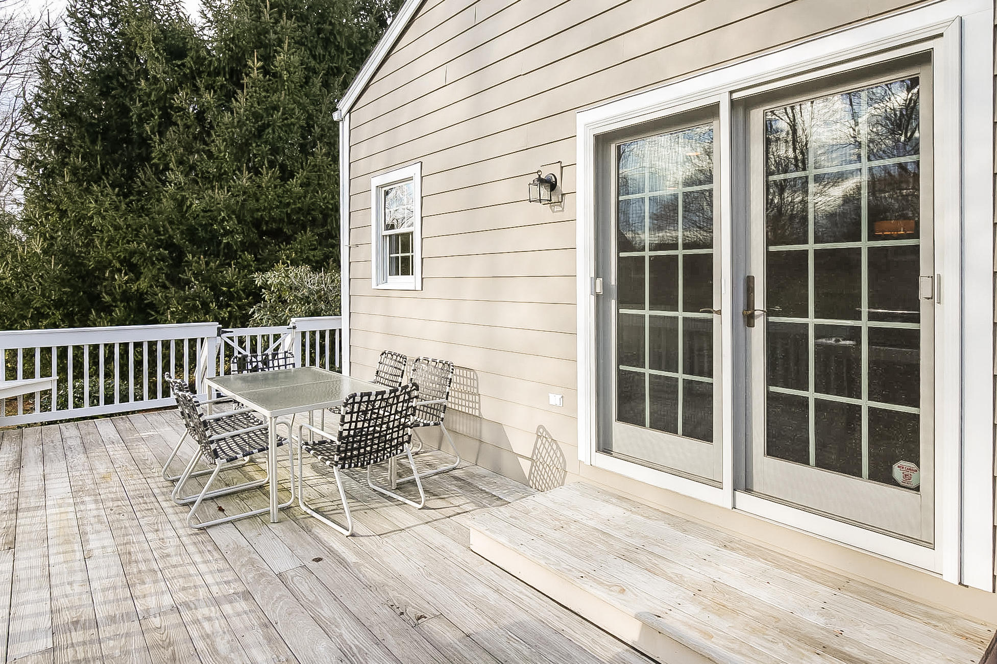 25 Miles Road Darien, CT 06820 - Photo 25 of 30 a view of a chair and table on the deck