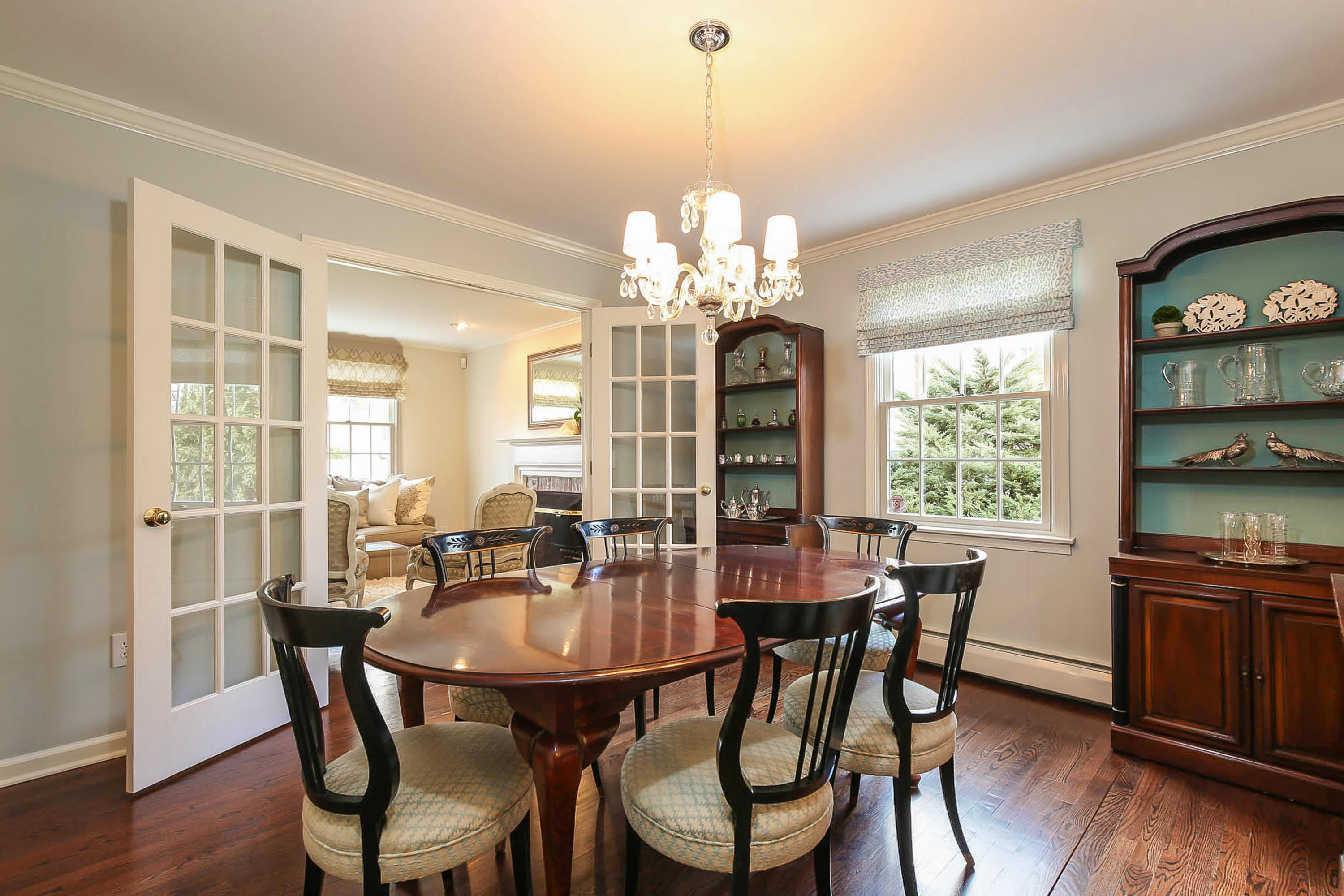 25 Miles Road Darien, CT 06820 - Photo 6 of 30 a dining room with furniture a chandelier and wooden floor
