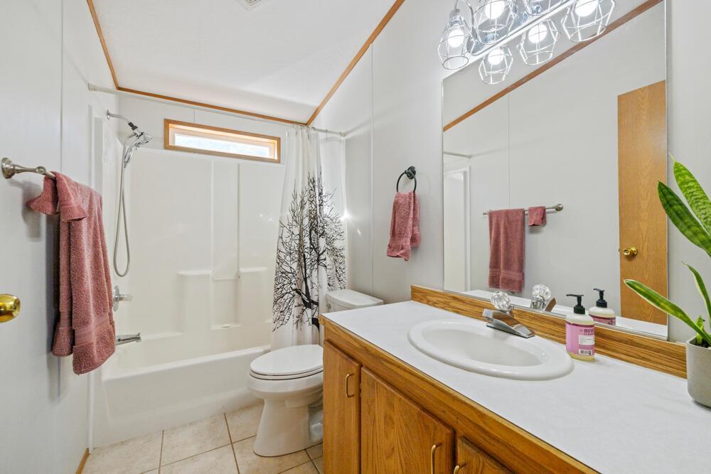 17550 South Poe Valley Road Klamath Falls, OR 97603 - Photo 31 of 59 a bathroom with a granite countertop sink toilet and shower