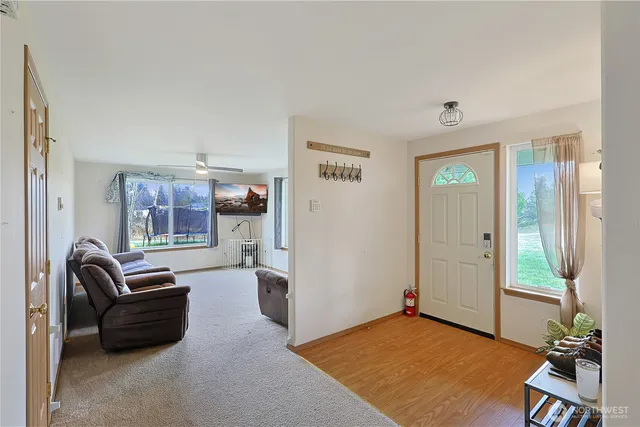a living room with furniture rug and window