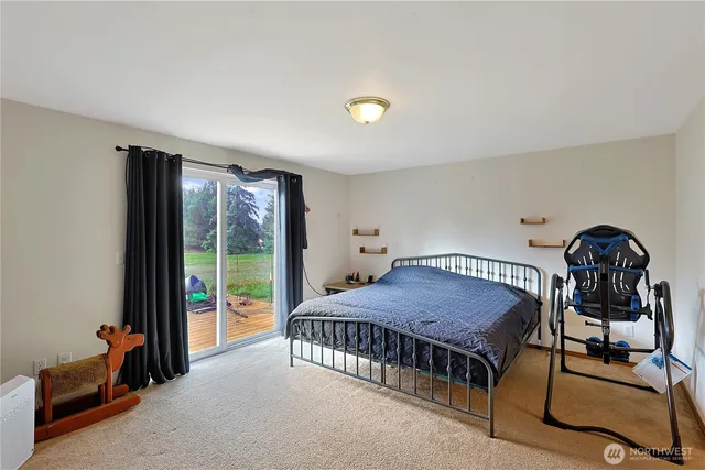 a bedroom with a bed a chandelier and balcony view