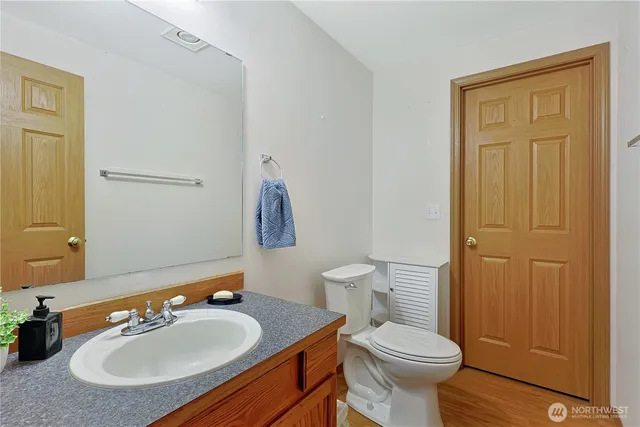 a bathroom with a sink toilet and a mirror