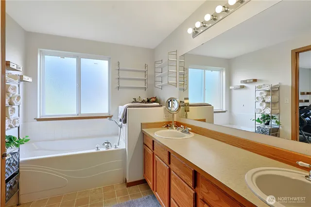 a bath room with a sink tub and a mirror