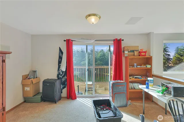 a living room with furniture a flat screen tv and a floor to ceiling window