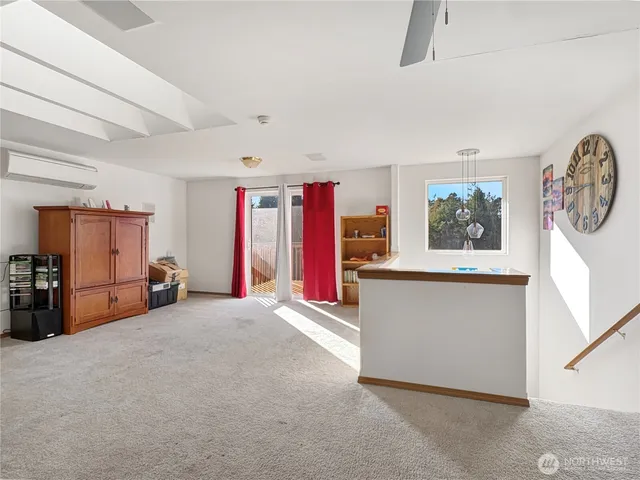 a view of a livingroom with furniture and a large window