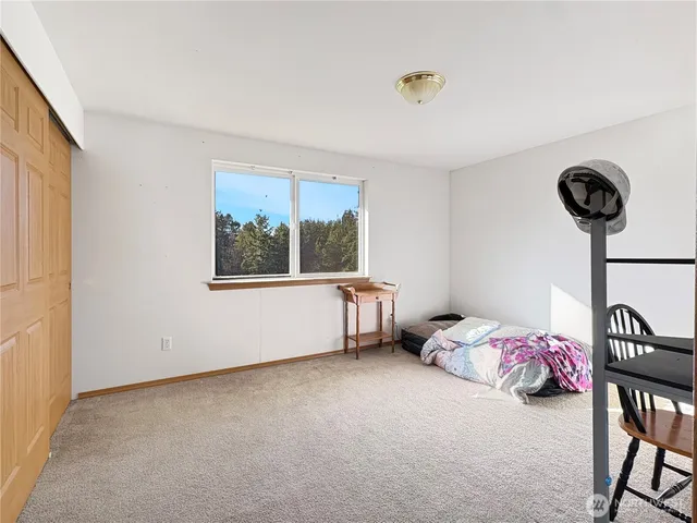 a bedroom with furniture and a window