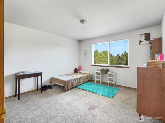 a living room with furniture and a baby crib