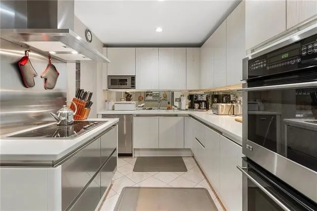 a kitchen with a sink stove and microwave