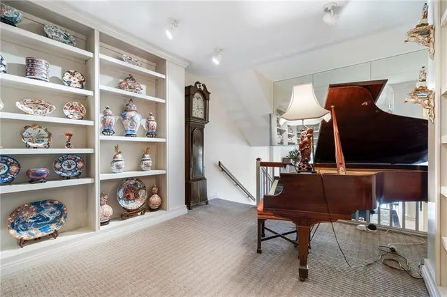 a spacious bedroom with a bed and wooden floor