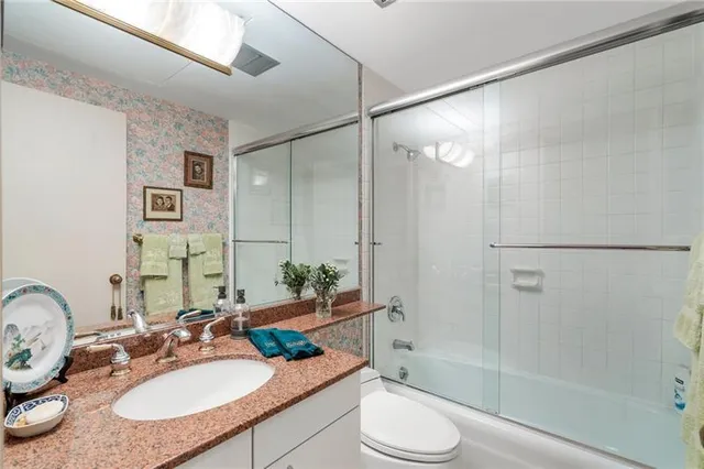 a bedroom with a bed lamp chandelier and a window