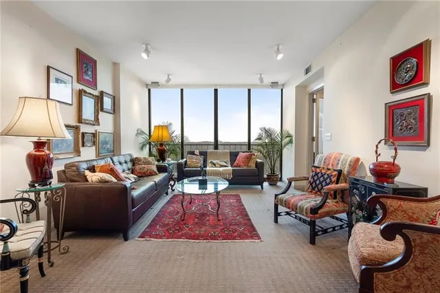a living room with furniture and a floor to ceiling window