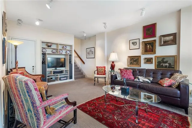 a living room with furniture fireplace and a large window
