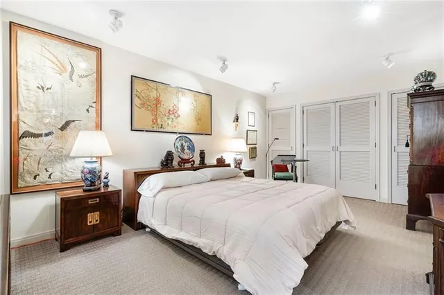 a bedroom with a bed and a refrigerator