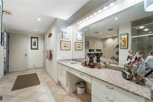 a bathroom with a sink mirror and shower