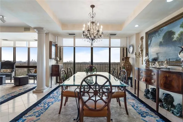 a view of a dining room with furniture large window and wooden floor
