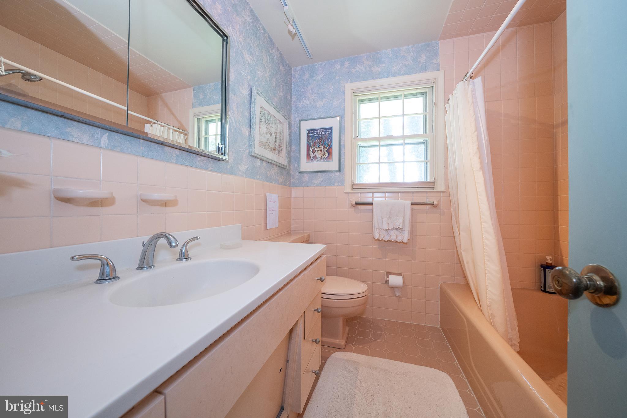 2227 North Stone Ridge Lane Villanova, PA 19085 - Photo 26 of 49 a bathroom with a sink a toilet and a mirror