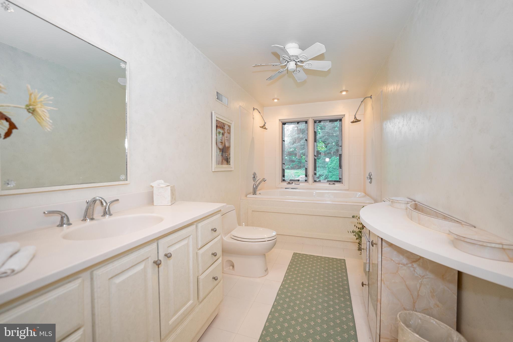 2227 North Stone Ridge Lane Villanova, PA 19085 - Photo 31 of 49 a bathroom with a sink a toilet a mirror and shower