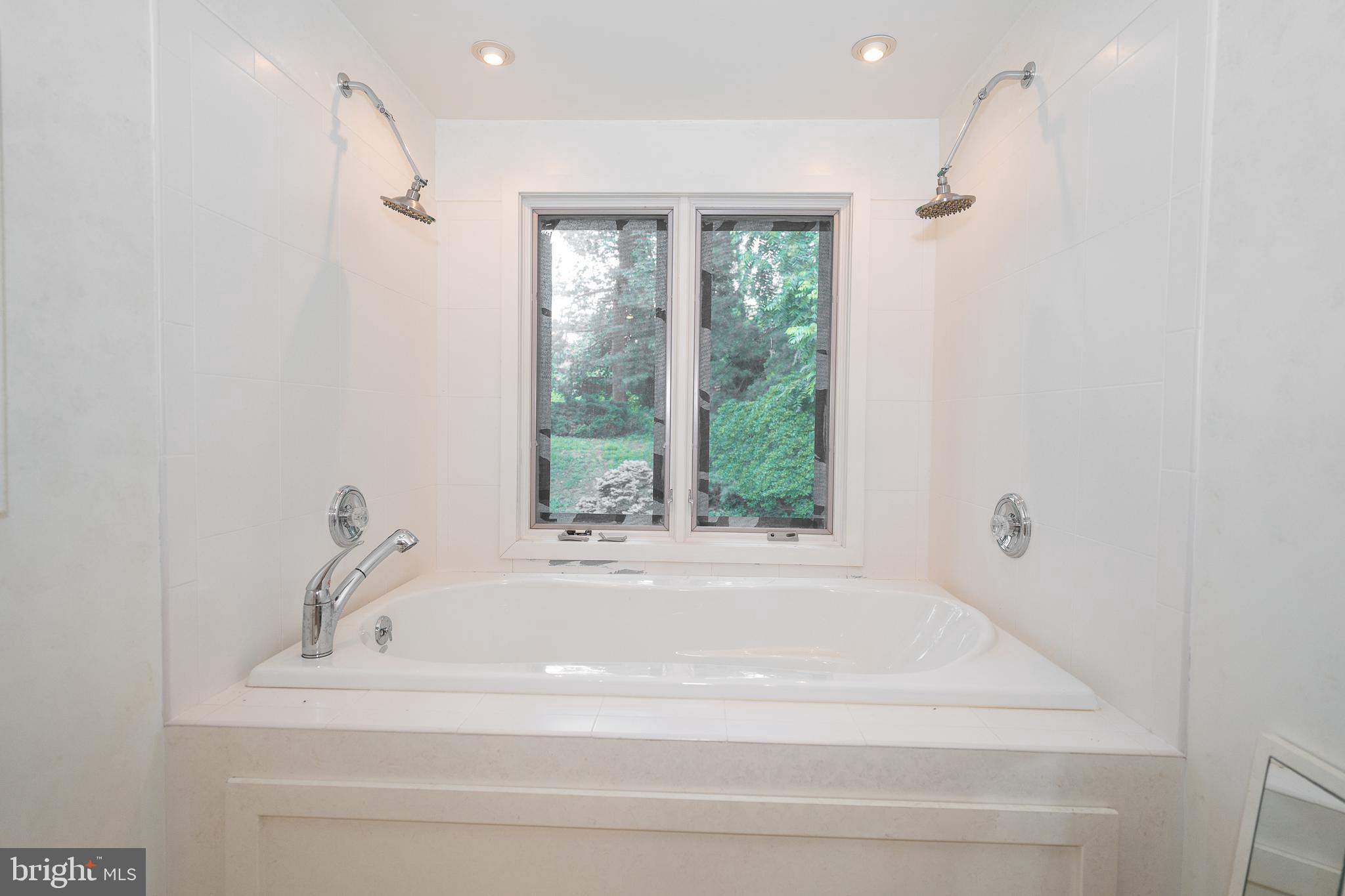 2227 North Stone Ridge Lane Villanova, PA 19085 - Photo 32 of 49 a bathroom with a bathtub and a window
