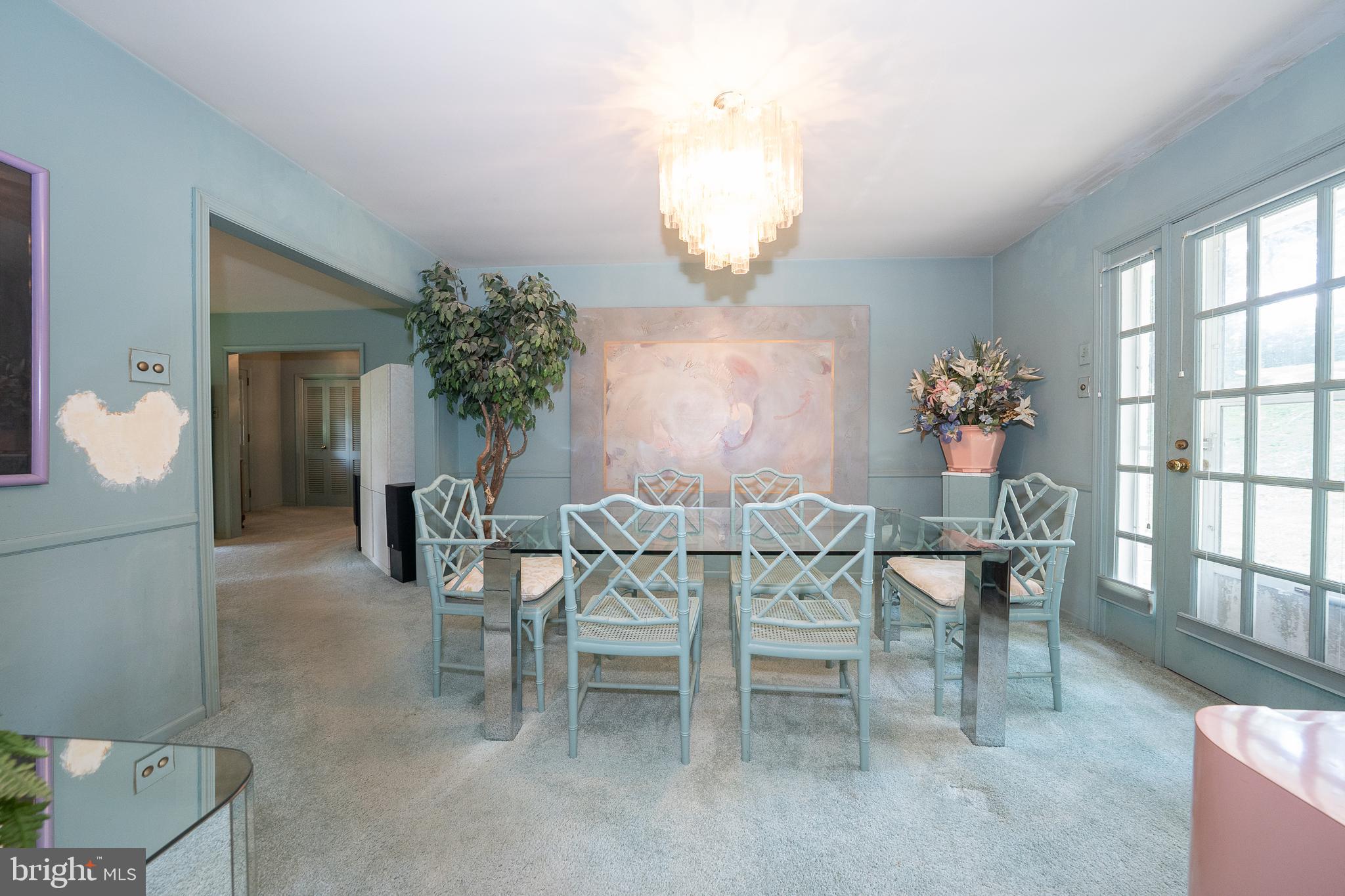 2227 North Stone Ridge Lane Villanova, PA 19085 - Photo 9 of 49 a dining room with furniture a potted plant and a chandelier