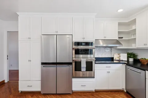 a living room with fireplace furniture and a large window