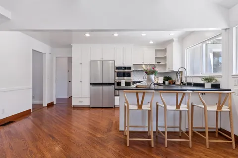 a living room with furniture a fireplace and a potted plant